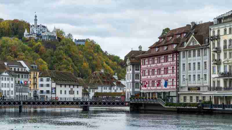 A scenic view of Chapel Bridge and historic architecture along the waterfront in Lucerne, Switzerland. - A scenic view of Chapel Bridge and historic architecture along the waterfront in Lucerne, Switzerland., tags: mit und - pexel